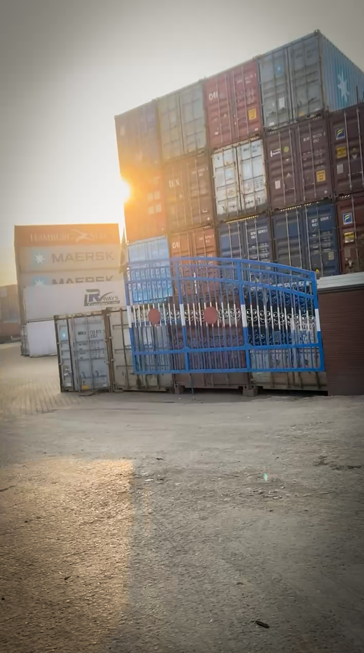 Geniluxe containers at dry port during customs clearance with stacked shipping containers